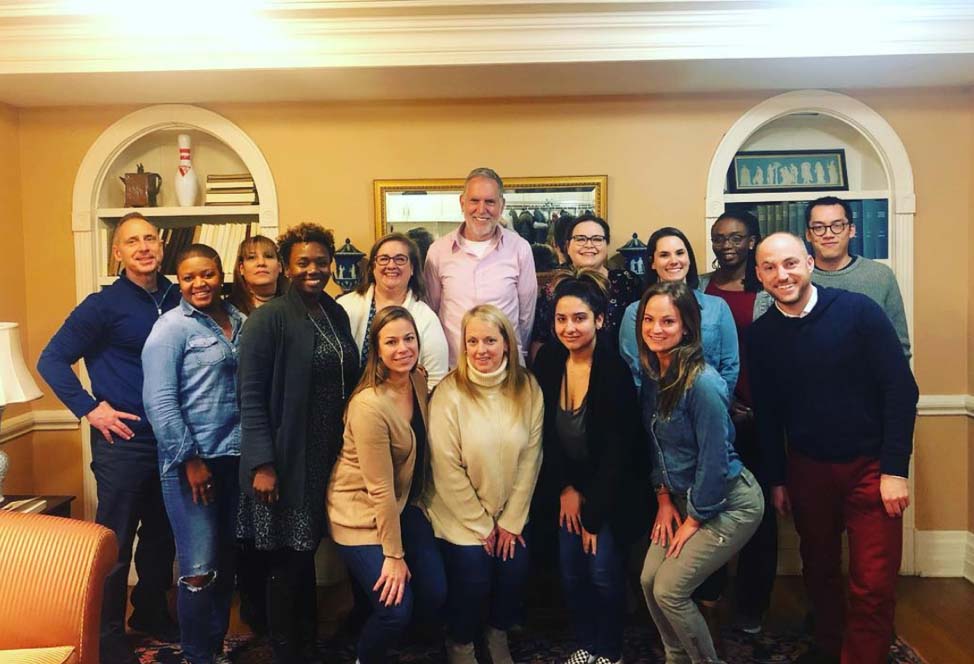 15 adults pose for a group portrait